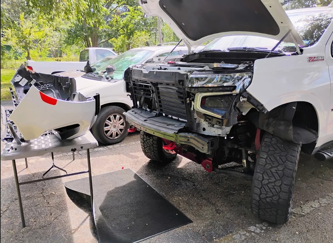 Front-end repair on a lifted truck — on-site service